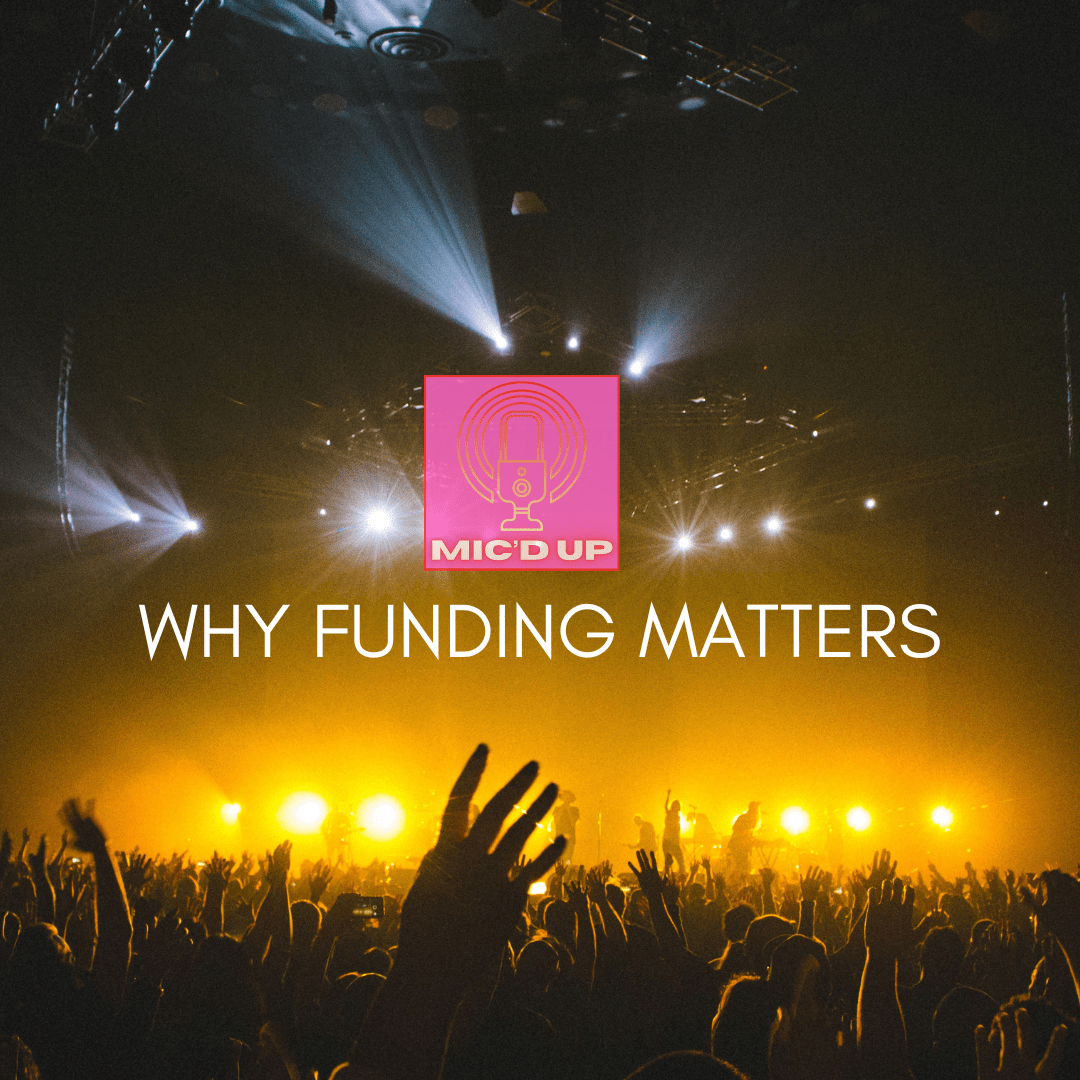 a large crowd in fron of a stage in the dark, lit by orange stage lights. White text is at the centre of the image reading 'why funding matters' with a microphone logo just above this text
